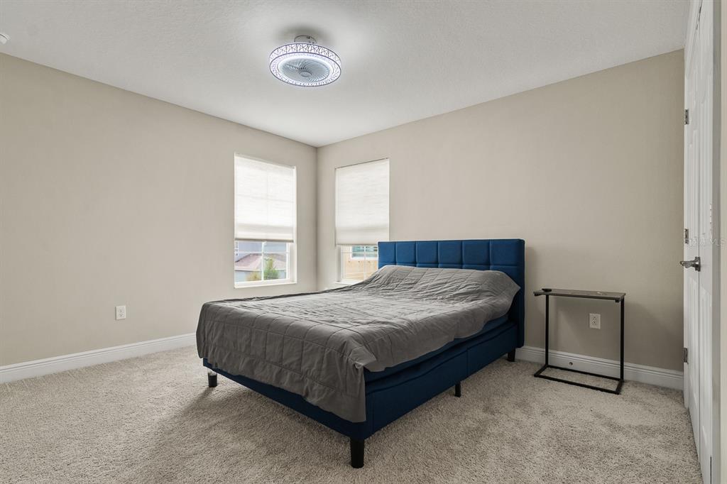 17880 Moon Rise Pass Land O Lakes, FL 34638 - Photo 25 of 43 a bed sitting in a bedroom next to a window