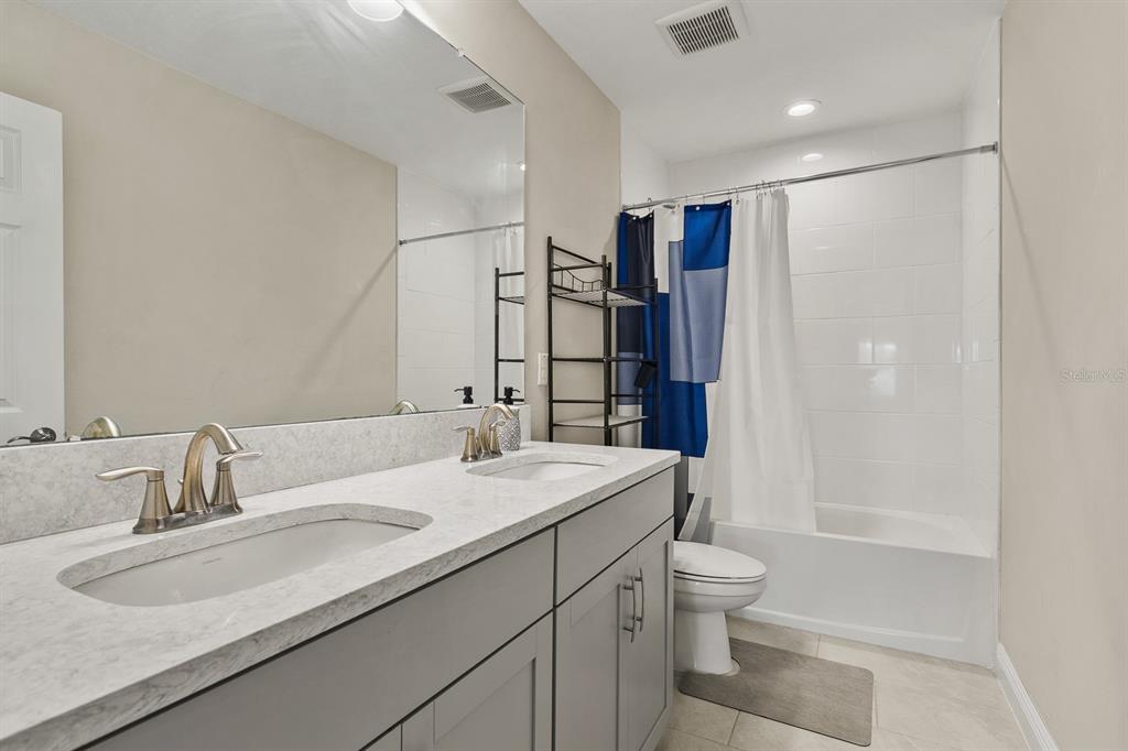 17880 Moon Rise Pass Land O Lakes, FL 34638 - Photo 28 of 43 a bathroom with a granite countertop sink toilet and shower