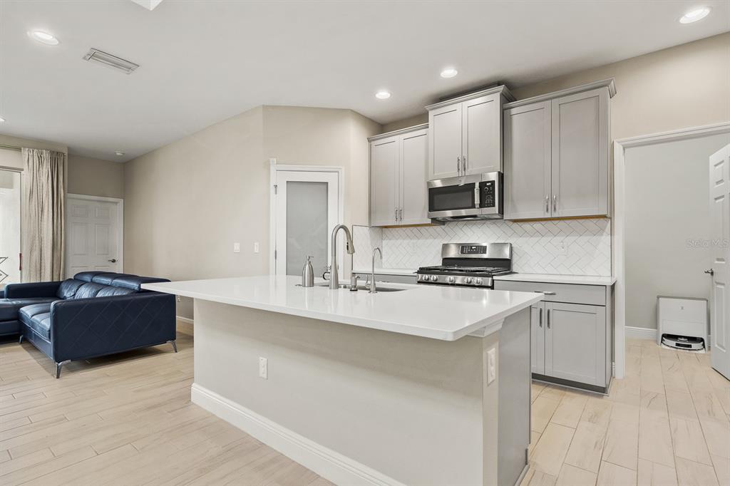 17880 Moon Rise Pass Land O Lakes, FL 34638 - Photo 10 of 43 a kitchen with a sink stove and cabinets