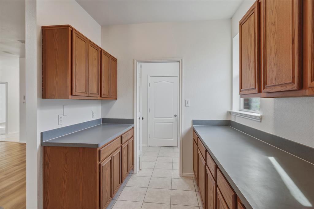 13509 Ponderosa Ranch Road Fort Worth, TX 76262 - Photo 11 of 33 Tons of cabinets and counters.