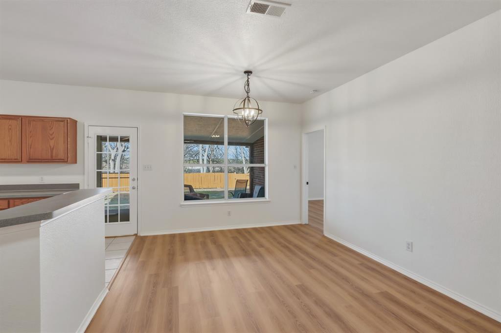 13509 Ponderosa Ranch Road Fort Worth, TX 76262 - Photo 19 of 33 Dining area overlooking backyard and covered patio.