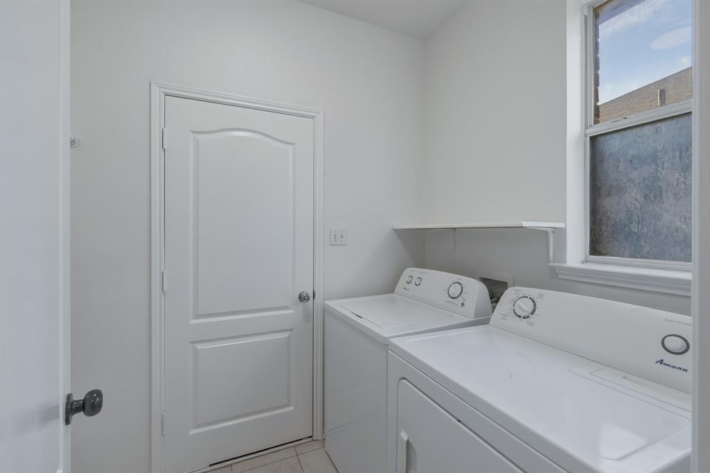 13509 Ponderosa Ranch Road Fort Worth, TX 76262 - Photo 21 of 33 Laundry room equipped with washer and dryer.