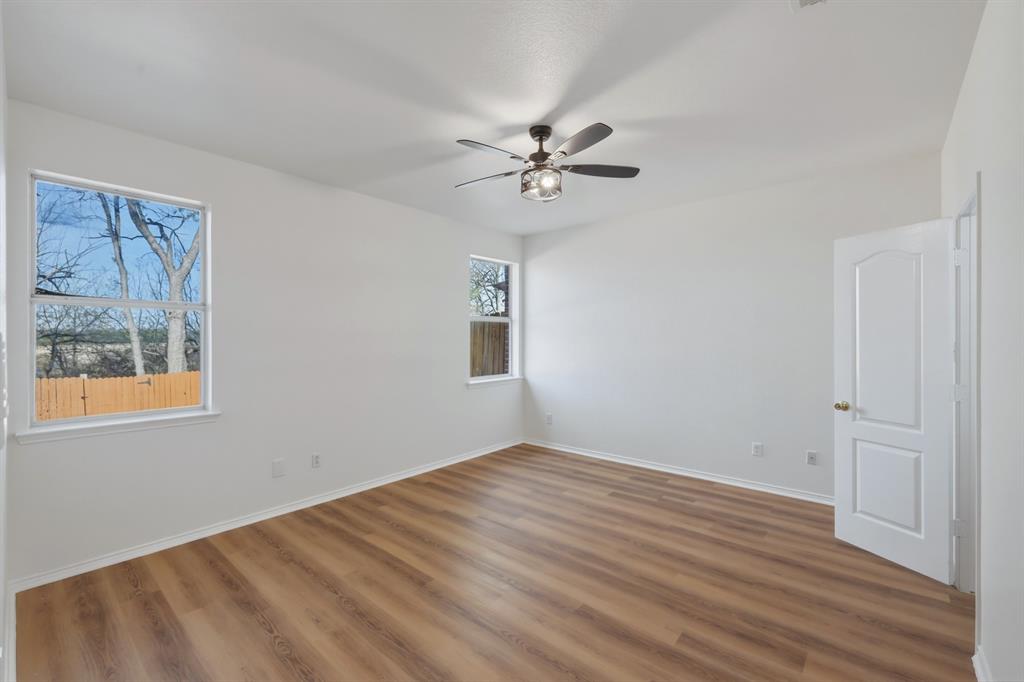 13509 Ponderosa Ranch Road Fort Worth, TX 76262 - Photo 22 of 33 Primary bedroom with backyard views.