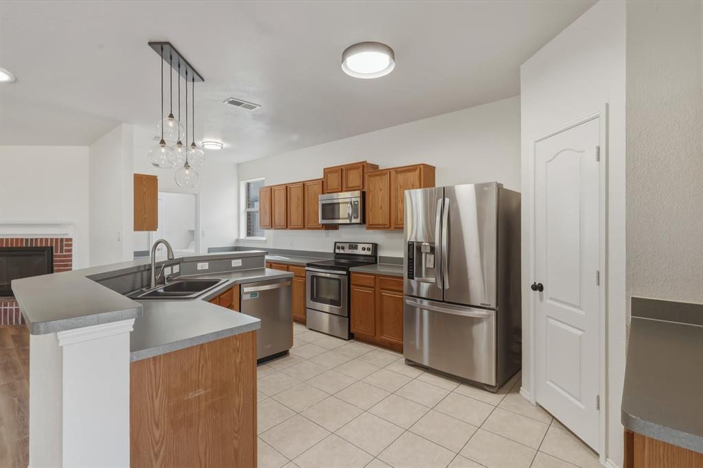 13509 Ponderosa Ranch Road Fort Worth, TX 76262 - Photo 7 of 33 Open concept kitchen overlooks living area.
