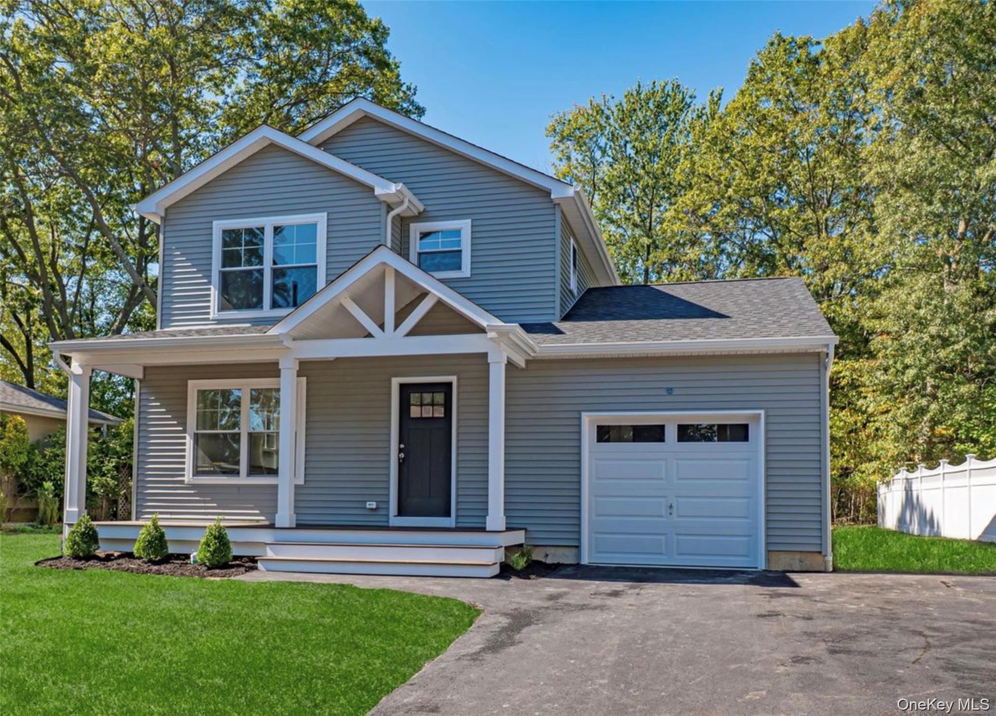 370 Canal Road Port Jefferson Station, NY 11776 - Photo 2 of 16 a front view of a house with a yard and garage