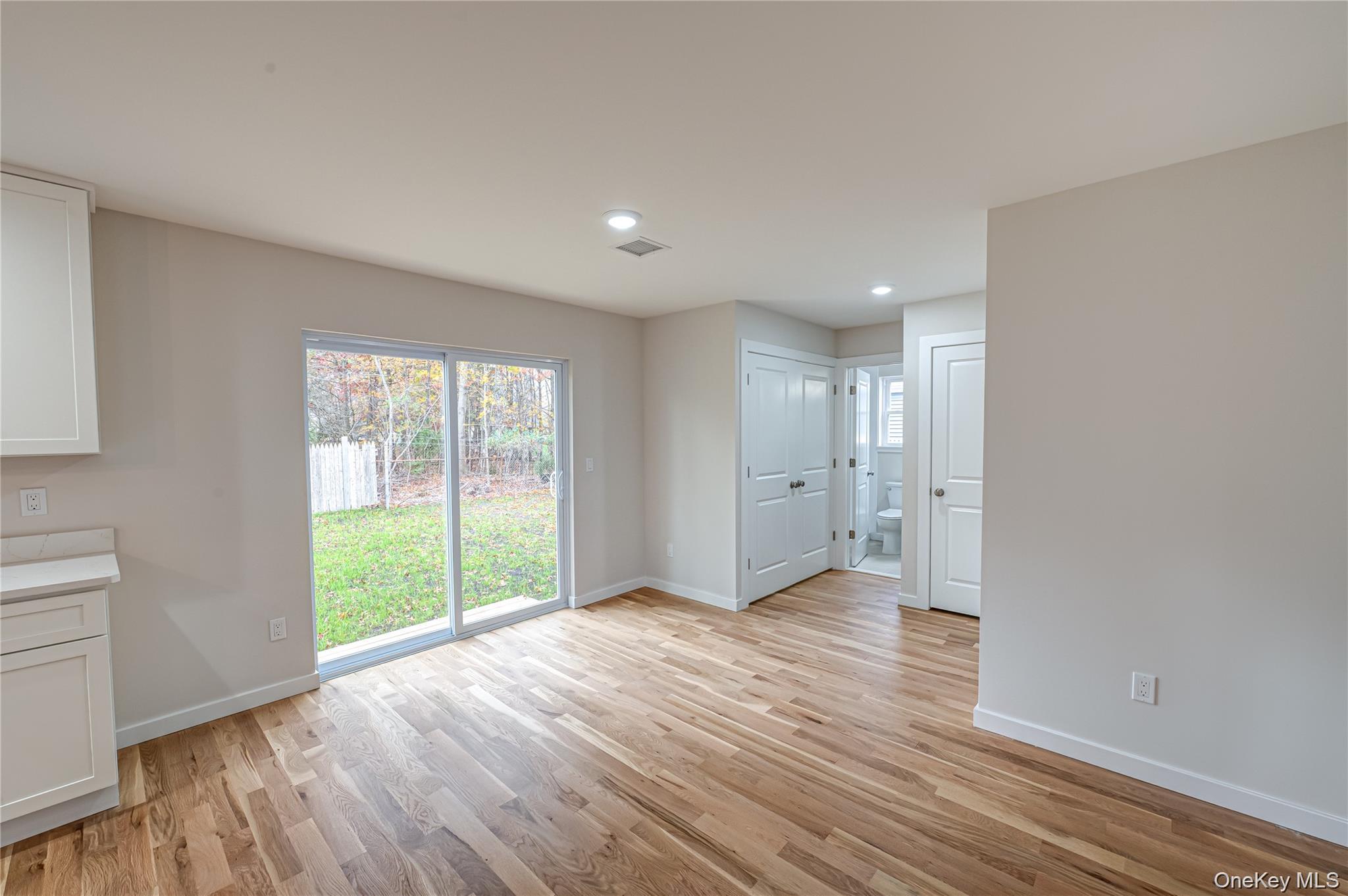 370 Canal Road Port Jefferson Station, NY 11776 - Photo 5 of 16 a view of an empty room with wooden floor and a window