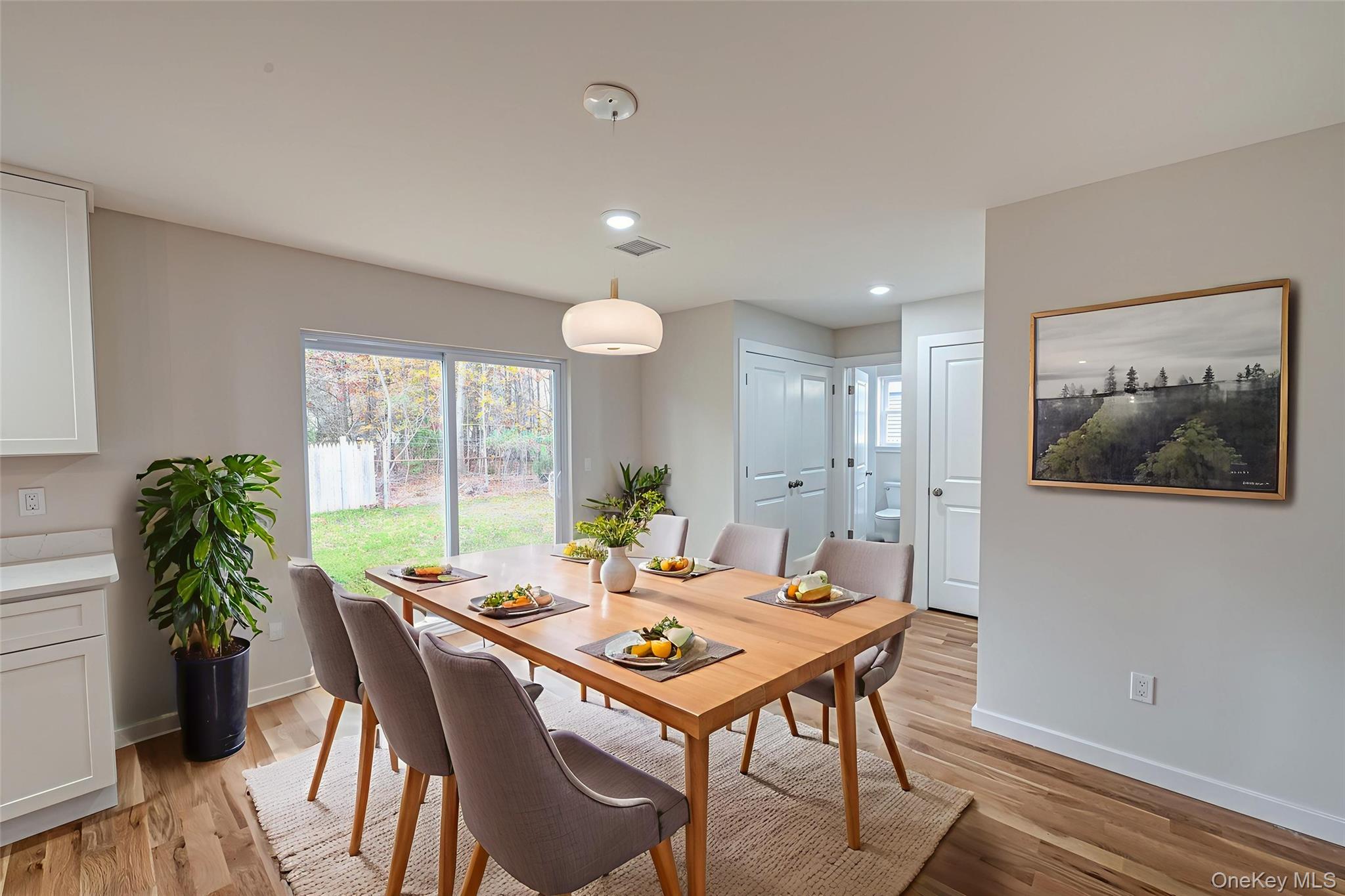 370 Canal Road Port Jefferson Station, NY 11776 - Photo 6 of 16 a view of a dining room with furniture window and wooden floor
