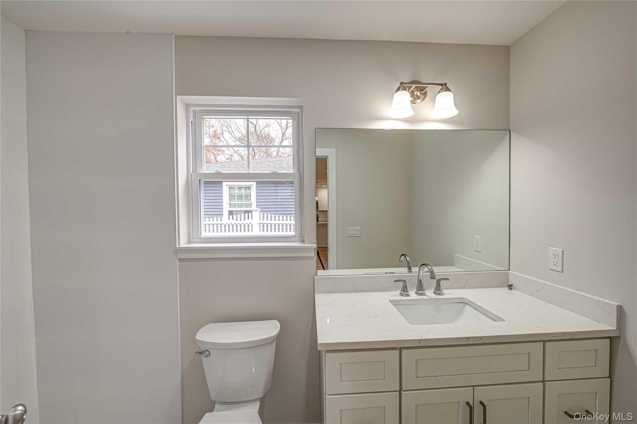 370 Canal Road Port Jefferson Station, NY 11776 - Photo 8 of 16 a bathroom with a toilet sink and mirror