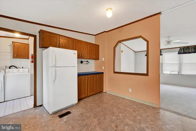 a utility room with refrigerator a washer and dryer
