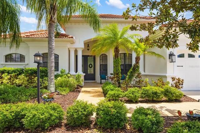 front view of a house with a yard and potted plants