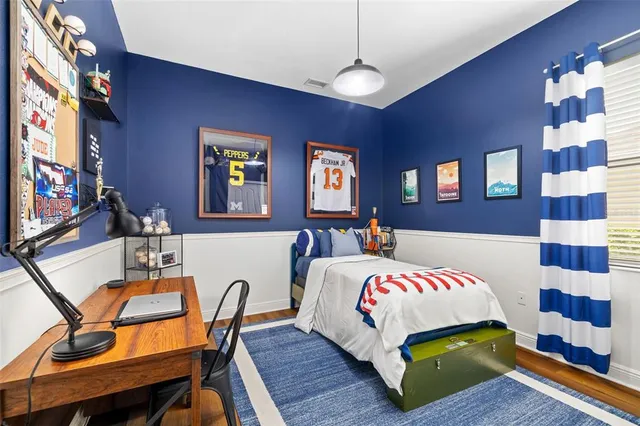 a view of a room that has a window and wooden floor