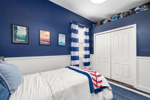 a view of a white house with a yard table and chairs