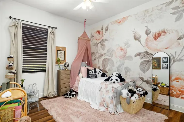 a view of a backyard with couches under an umbrella