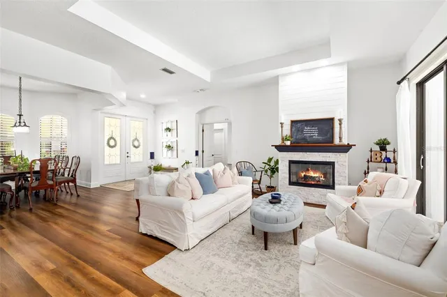 a living room with furniture a fireplace a flat screen tv and a fireplace