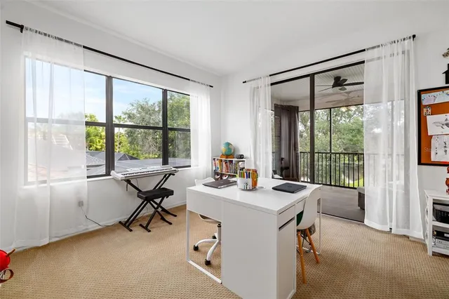 an aerial view of a house with a garden and lake view