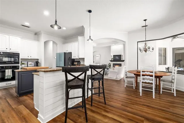 a large kitchen with a table and chairs