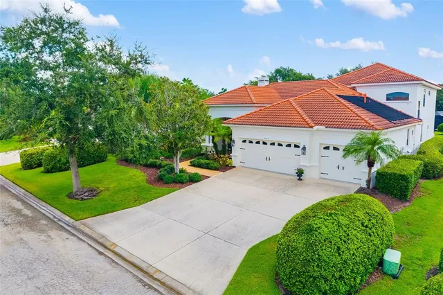 a view of a house with a yard and potted plants