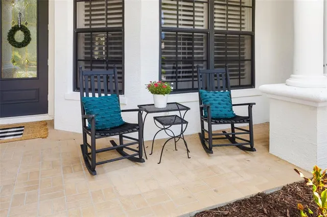 a balcony with a bench and a potted plant