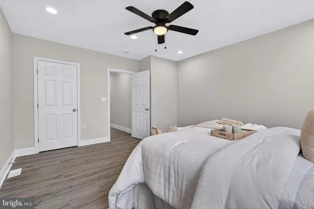 a bedroom with a bed and a ceiling fan