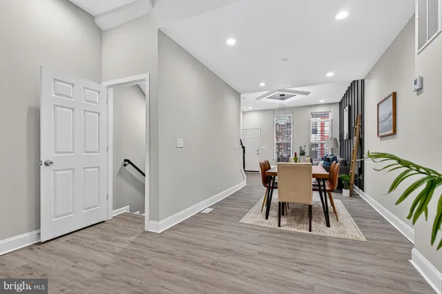 a dining room with furniture and wooden floor