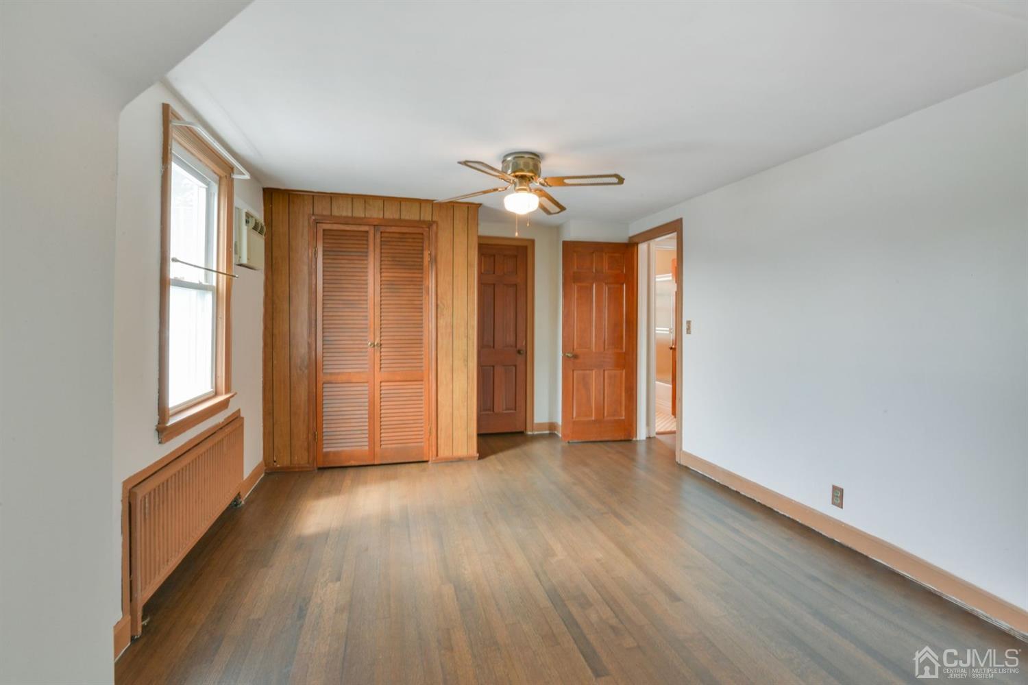 120 Harvard Road Linden, NJ 07036 - Photo 15 of 19 wooden floor in an empty room with a window