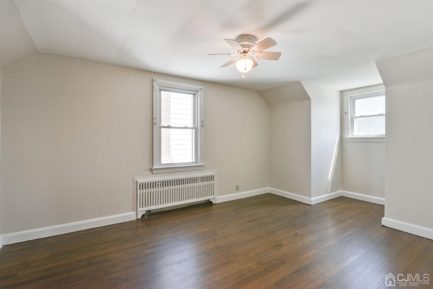 120 Harvard Road Linden, NJ 07036 - Photo 16 of 19 an empty room with wooden floor and windows
