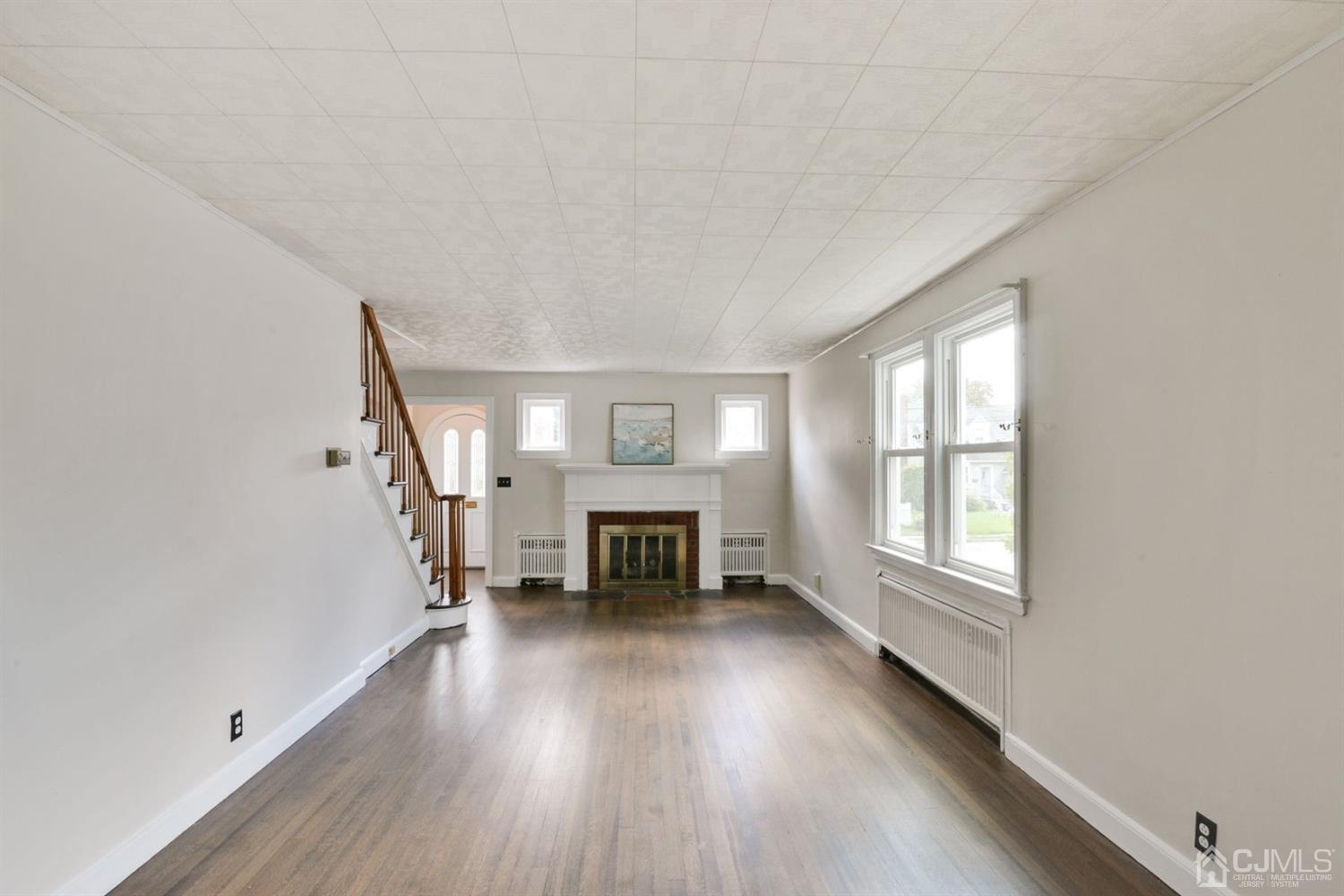 120 Harvard Road Linden, NJ 07036 - Photo 4 of 19 an empty room with furniture and fireplace