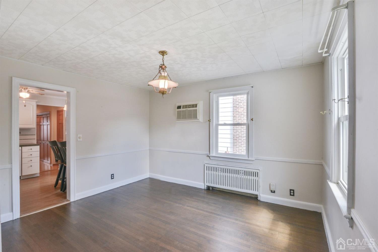 120 Harvard Road Linden, NJ 07036 - Photo 7 of 19 a view of empty room with wooden floor and fan