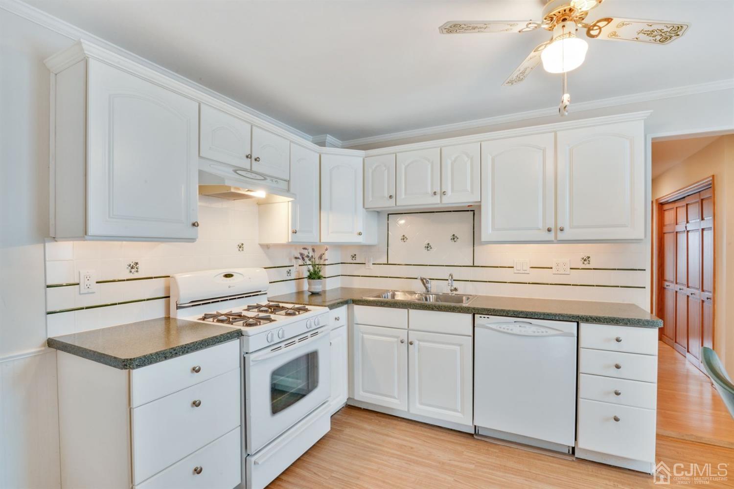 120 Harvard Road Linden, NJ 07036 - Photo 8 of 19 a kitchen with white cabinets stainless steel appliances and sink
