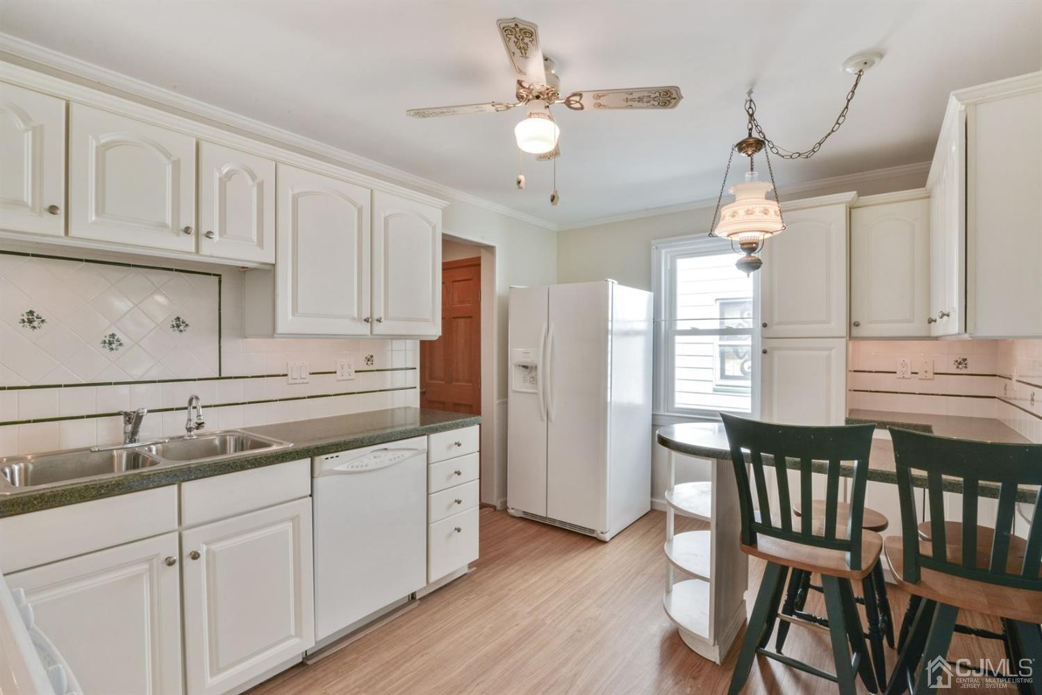120 Harvard Road Linden, NJ 07036 - Photo 9 of 19 a kitchen with granite countertop white cabinets white appliances and sink