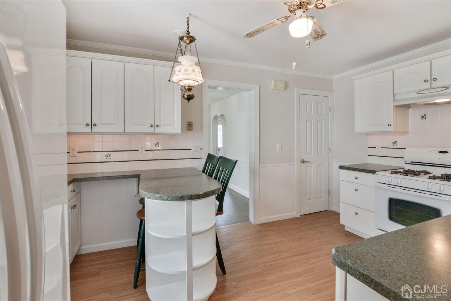 120 Harvard Road Linden, NJ 07036 - Photo 10 of 19 a kitchen with stainless steel appliances granite countertop a white cabinets and a stove