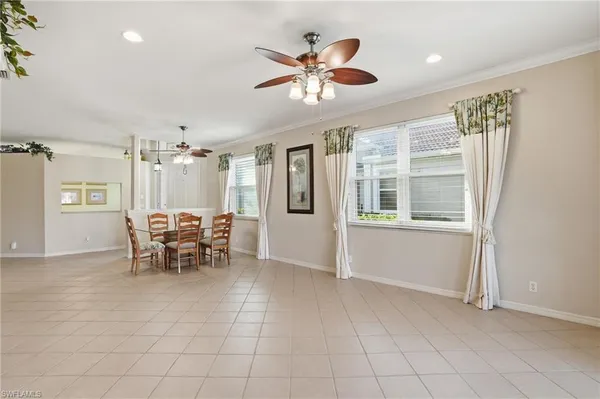 a view of a livingroom with furniture and chandelier fan