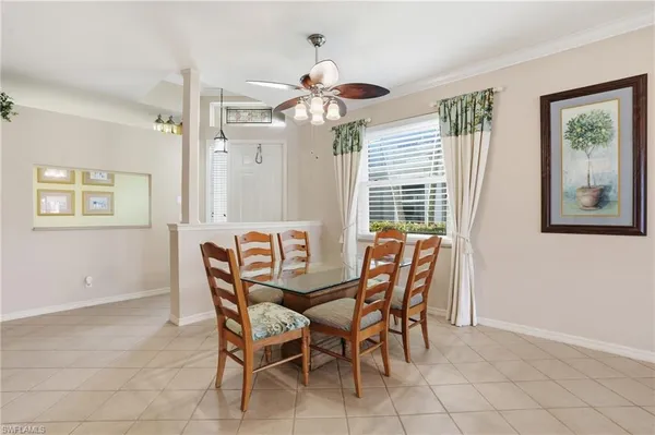 a dining room with furniture and window