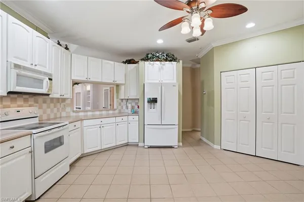 a kitchen with cabinets and stainless steel appliances