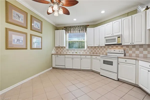 a kitchen with stainless steel appliances granite countertop a stove sink and cabinets
