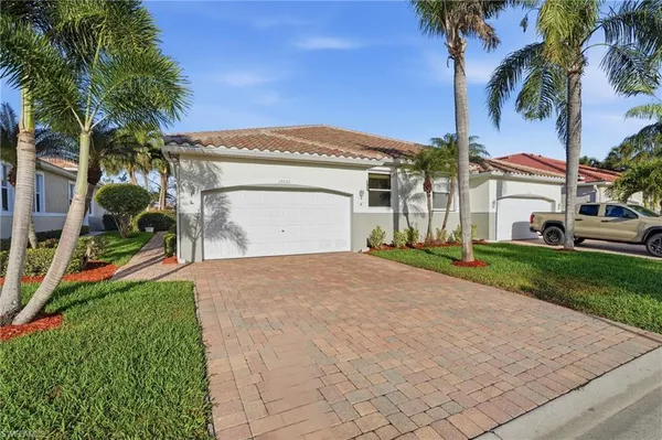 a front view of a house with a yard and garage