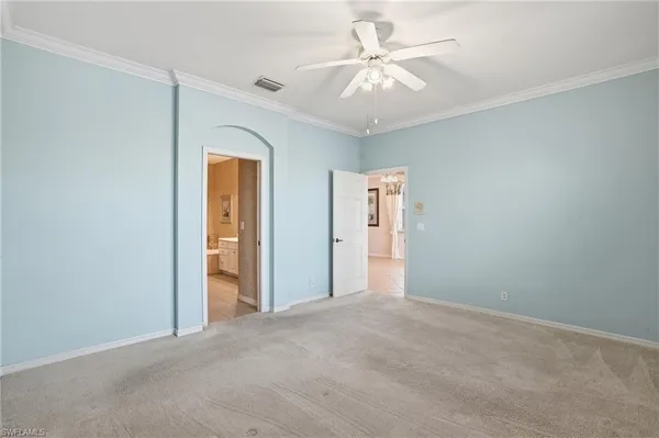 a view of a big room with closet and a chandelier fan