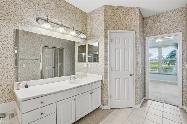a spacious bathroom with a double vanity sink mirror and