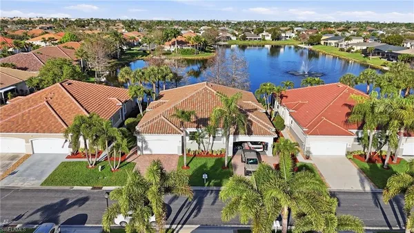an aerial view of residential houses with outdoor space and river