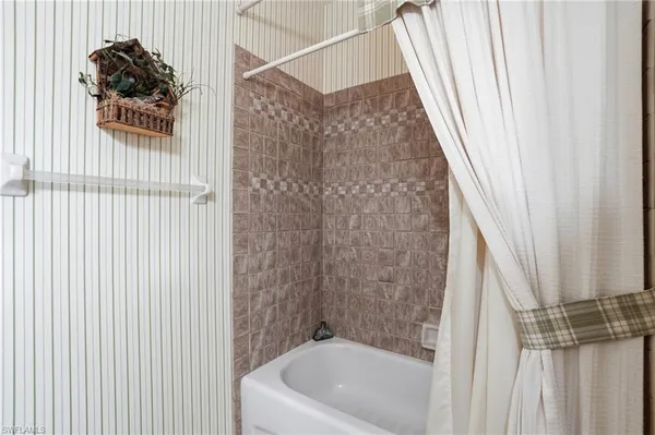 a bathroom with a shower curtain and a sink