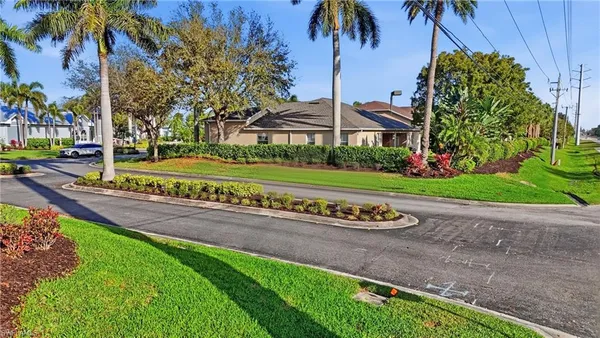 a front view of a house with a garden and trees