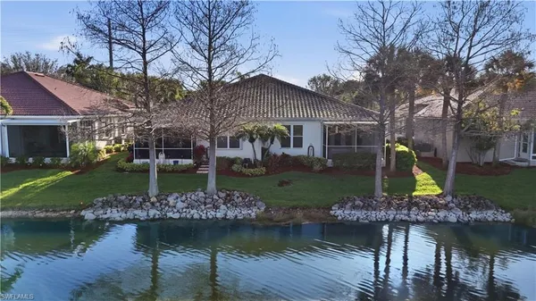 a front view of a house with a yard and a garden
