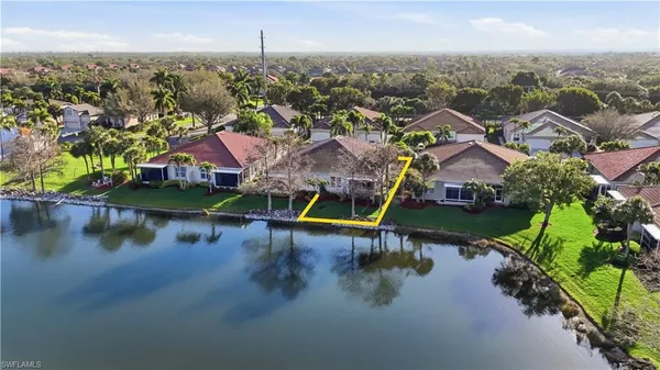 an aerial view of residential houses with lake view