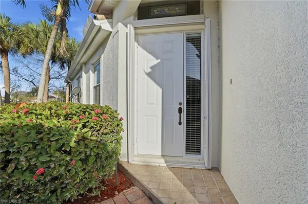a view of a house with a flower garden