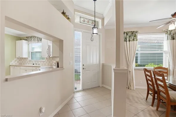 a bathroom with a sink a chair a mirror and a shower