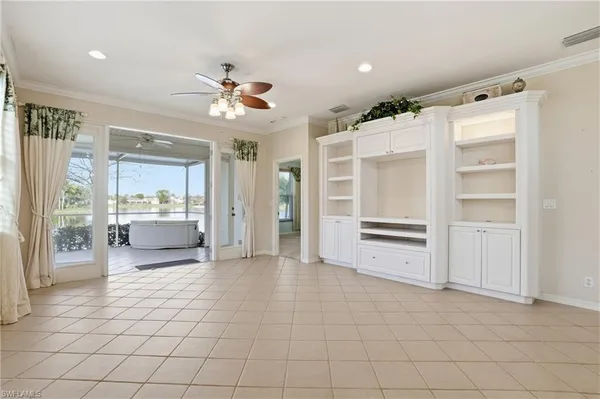 a view of a kitchen with furniture and a ceiling fan