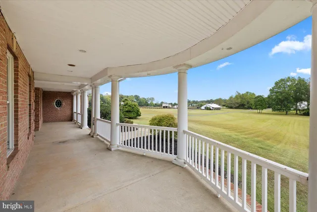 a kitchen with a sink stove and wooden floor