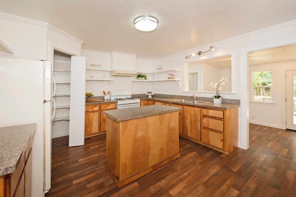 17-1033 Volcano Road Mountain View, HI 96760 - Photo 13 of 25 a kitchen with stainless steel appliances granite countertop a stove a sink dishwasher and a refrigerator