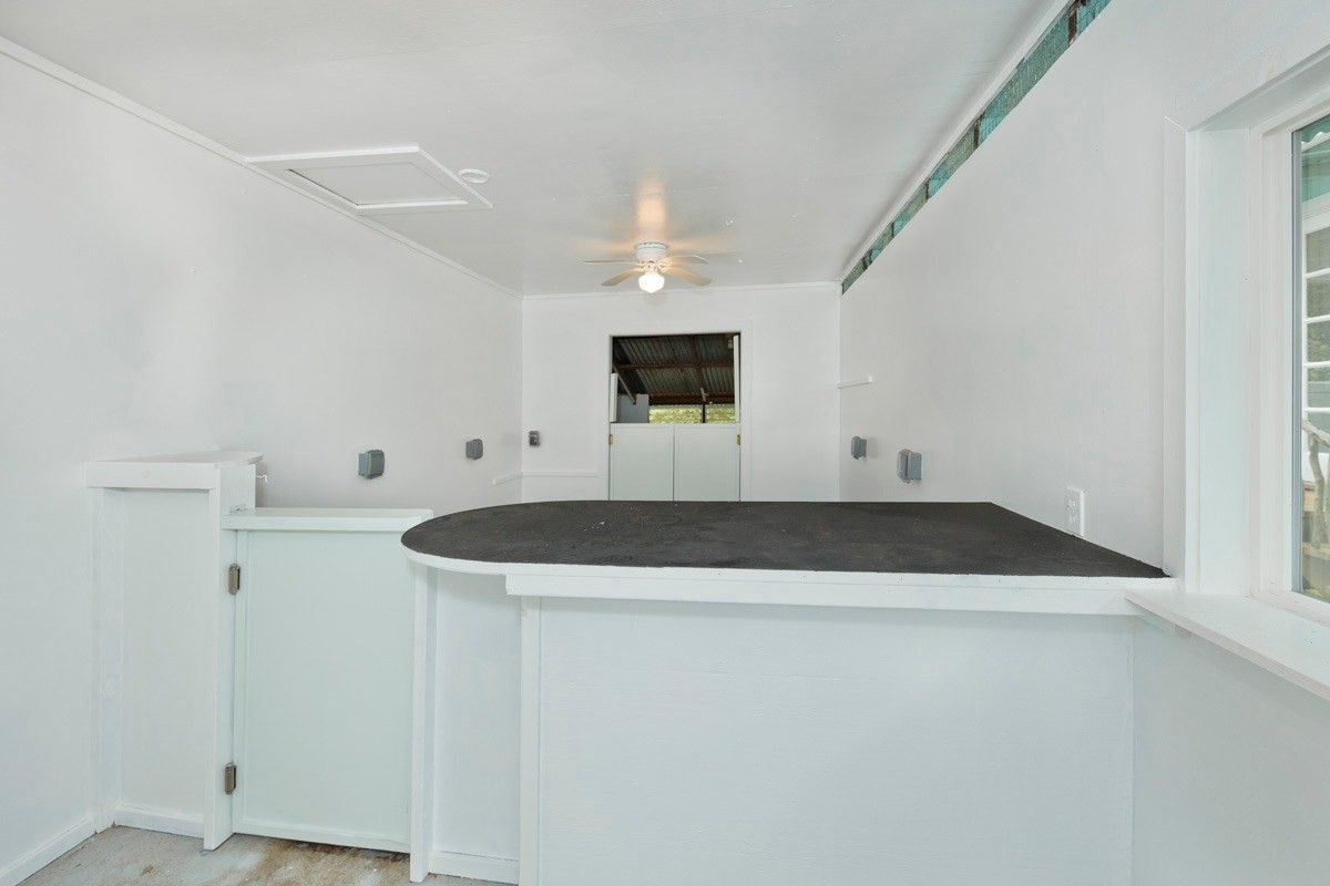 17-1033 Volcano Road Mountain View, HI 96760 - Photo 21 of 25 a bathroom with a granite countertop sink and white cabinets