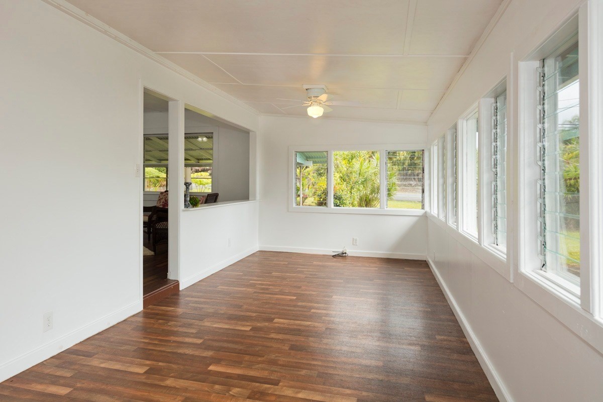 17-1033 Volcano Road Mountain View, HI 96760 - Photo 8 of 25 wooden floor in an empty room with a window